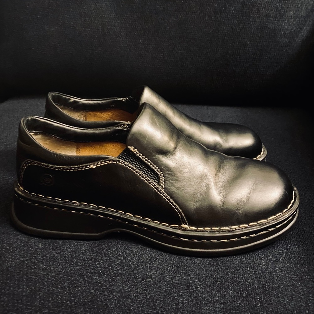 BORN men’s black leather slip shoes.